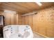 Indoor hot tub with wooden walls, overhead lighting and white metal rack at 1660 Moveen Hts, Monument, CO 80132