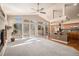 Open-concept living area with fireplace, island kitchen, and patio access via sliding glass doors at 1660 Moveen Hts, Monument, CO 80132