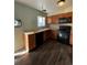 Galley-style kitchen with wood cabinets and modern appliances at 16786 E Kent Dr, Aurora, CO 80013