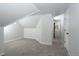 Finished attic space with neutral carpet, tongue and groove paneling, and ample natural light at 3745 Fairfax St, Denver, CO 80207