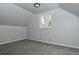 Finished attic space featuring neutral carpet and tongue and groove paneling at 3745 Fairfax St, Denver, CO 80207