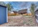 Spacious dirt backyard featuring a detached garage and wood fence at 3745 Fairfax St, Denver, CO 80207
