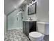 This renovated bathroom features geometric floor tiles, black fixtures, and a glass walk-in shower at 3745 Fairfax St, Denver, CO 80207