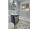 This bathroom features a tub with tiled walls, and a vanity with storage at 3745 Fairfax St, Denver, CO 80207