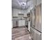 Kitchen featuring stainless steel appliances, granite countertops, white cabinets, and hardwood floors at 3745 Fairfax St, Denver, CO 80207