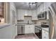 Well-lit kitchen features stainless steel appliances and granite countertops at 3745 Fairfax St, Denver, CO 80207