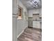 Updated kitchen featuring stainless steel appliances, granite countertops, white cabinets, and hardwood floors at 3745 Fairfax St, Denver, CO 80207