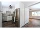 Modern kitchen featuring stainless steel appliances, granite countertops, white cabinets, and hardwood floors at 3745 Fairfax St, Denver, CO 80207