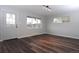 Bright living room featuring dark, wood-look floors, fresh paint, and plenty of natural light at 3745 Fairfax St, Denver, CO 80207