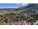 Scenic aerial view of a forest landscape featuring majestic mountains and a sprawling forest at 4835 Abo Ln, Monument, CO 80132