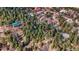 An aerial view of a community featuring homes nestled among pine trees and mountainous terrain at 4835 Abo Ln, Monument, CO 80132