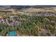 A beautiful aerial view showcasing a community set among a pine tree forest with mountain views at 4835 Abo Ln, Monument, CO 80132