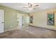 Serene bedroom features a large window and neutral tones, adjacent to bathroom at 4835 Abo Ln, Monument, CO 80132