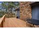 Wooden deck with stone accents, seating, and outdoor dining area at 4835 Abo Ln, Monument, CO 80132