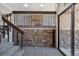 Unique entryway with stone accent wall, wooden railing, carpeted stairs and natural light at 4835 Abo Ln, Monument, CO 80132