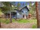 Unique home exterior featuring stone accents, wooden deck and picturesque forest setting at 4835 Abo Ln, Monument, CO 80132