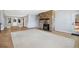Spacious living room with a stone fireplace, wood floors, and access to a deck offering seamless indoor-outdoor living at 4835 Abo Ln, Monument, CO 80132