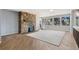 Cozy living area featuring a stone fireplace, wood flooring, and large windows providing ample natural light and scenic views at 4835 Abo Ln, Monument, CO 80132