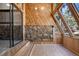 Inviting sunroom with wood paneling, stone accents, and large windows for scenic views at 4835 Abo Ln, Monument, CO 80132