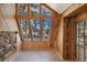 Bright sunroom featuring wood paneling, stone accents and multiple large windows at 4835 Abo Ln, Monument, CO 80132