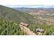 Aerial view of houses nestled in a mountainous area with distant mountain views at 1729 Santa Fe Mountain Rd, Evergreen, CO 80439
