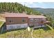 Aerial view of home showcasing deck and mountain views at 1729 Santa Fe Mountain Rd, Evergreen, CO 80439