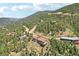 Aerial view showcasing a cluster of houses in a wooded mountain setting at 1729 Santa Fe Mountain Rd, Evergreen, CO 80439
