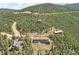 Aerial view of a residential area in a mountainous region with tree-covered slopes at 1729 Santa Fe Mountain Rd, Evergreen, CO 80439