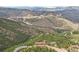 Aerial view of a house nestled in a mountainous area with stunning views at 1729 Santa Fe Mountain Rd, Evergreen, CO 80439