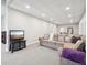 Finished basement with a comfortable sectional sofa and TV at 1729 Santa Fe Mountain Rd, Evergreen, CO 80439