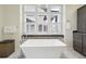 Spa-like bathroom with large soaking tub and shutters at 1729 Santa Fe Mountain Rd, Evergreen, CO 80439