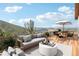 Relaxing deck with mountain views, outdoor furniture, and umbrella at 1729 Santa Fe Mountain Rd, Evergreen, CO 80439