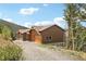 House exterior showcasing a driveway and mountain backdrop at 1729 Santa Fe Mountain Rd, Evergreen, CO 80439