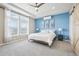 Main bedroom with blue accent wall and mountain views at 1729 Santa Fe Mountain Rd, Evergreen, CO 80439