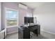 Spacious office with a desk, window views, and purple walls at 1729 Santa Fe Mountain Rd, Evergreen, CO 80439