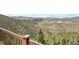 Stunning mountain views from deck overlooking trees and hills at 1729 Santa Fe Mountain Rd, Evergreen, CO 80439