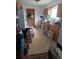 Functional kitchen with ample cabinet space, linoleum flooring, and natural light from the window, awaiting updates at 6027 W 61St Pl, Arvada, CO 80003