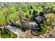 Stunning aerial view of home overlooking the golf course and tree-lined street at 6990 W 9Th Pl, Lakewood, CO 80214