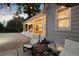 Inviting back porch with string lights, comfortable seating, and a view of the surrounding yard at 6990 W 9Th Pl, Lakewood, CO 80214