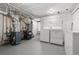 An unfinished basement with a washer, dryer, and additional equipment at 6990 W 9Th Pl, Lakewood, CO 80214