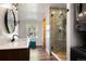 Modern bathroom featuring a glass enclosed shower, unique vanity, and wood floors for a spa-like feel at 6990 W 9Th Pl, Lakewood, CO 80214