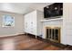 Bright bedroom featuring a fireplace, built-in storage, and natural light from the windows at 6990 W 9Th Pl, Lakewood, CO 80214
