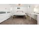 A cozy bedroom with carpet, a metal bed frame, and built-in storage drawers at 6990 W 9Th Pl, Lakewood, CO 80214
