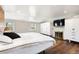 Bright bedroom featuring a fireplace, large bed, built-in storage, and natural light from the windows at 6990 W 9Th Pl, Lakewood, CO 80214