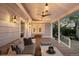 Inviting covered porch with comfortable seating, ceiling fans, and stylish lighting at 6990 W 9Th Pl, Lakewood, CO 80214