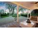 Relaxing covered porch featuring comfortable seating with views of the serene outdoors at 6990 W 9Th Pl, Lakewood, CO 80214