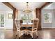 Elegant dining room featuring wood accents, chandelier, table with seating for four at 6990 W 9Th Pl, Lakewood, CO 80214