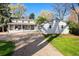 Charming gray two-story home with a detached garage, spacious lawn and driveway at 6990 W 9Th Pl, Lakewood, CO 80214