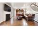 Comfortable Gathering room with fireplace, shelving, staircase and leather sofa at 6990 W 9Th Pl, Lakewood, CO 80214