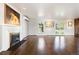 Spacious living room with fireplace, bright lighting, hardwood floors and neutral colors at 6990 W 9Th Pl, Lakewood, CO 80214